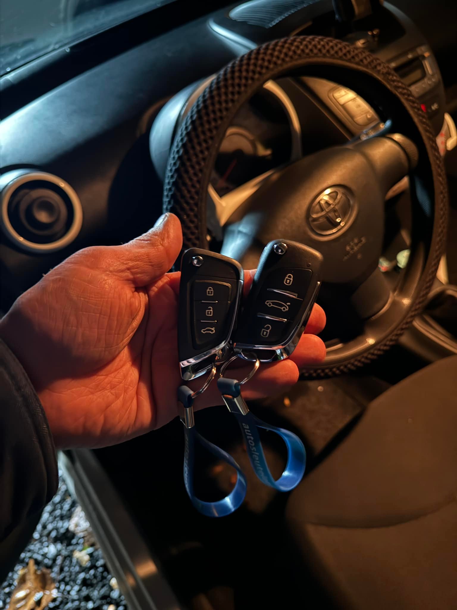 Professional automotive locksmith programming replacement Toyota car keys.